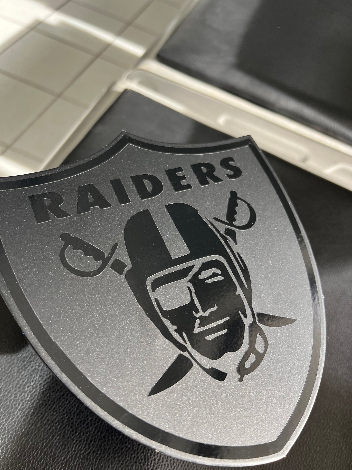 Black on black Raiders shield hitch cover