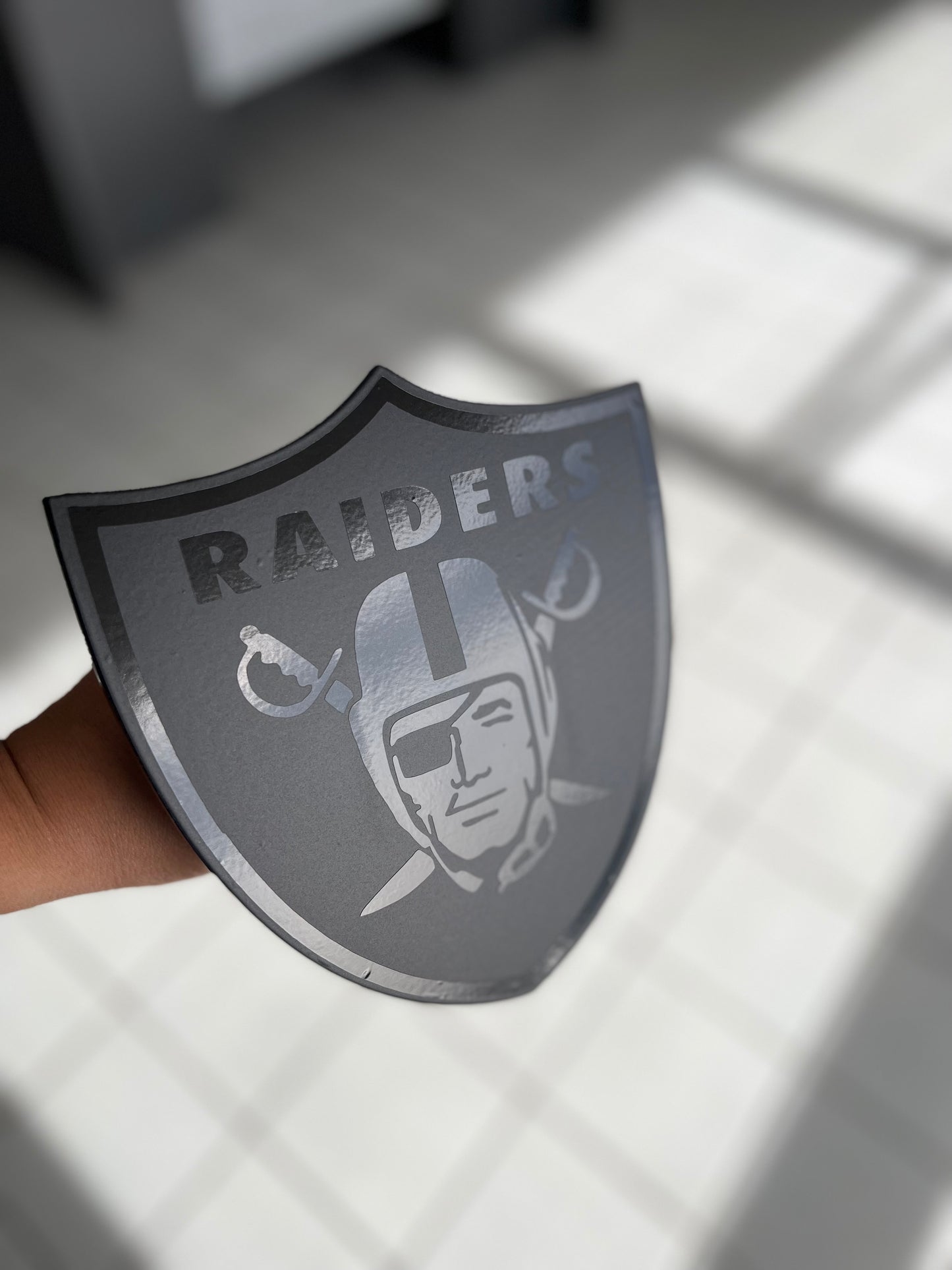 Black on black Raiders shield hitch cover